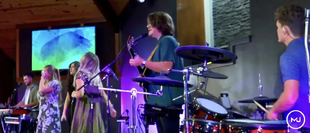 The worship band — drums, guitar and singers — in the middle of a song.